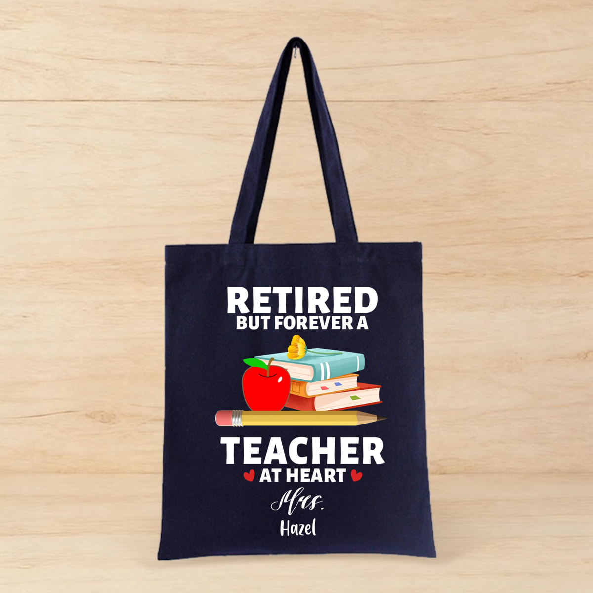 Personalized Canvas Tote Bag With a Cute Design Featuring The Message "RETIRED BUT FOREVER A TEACHER AT HEART," a Perfect Gift For Retired Teachers, Suitable For Retirement Parties Or Farewell Presents.